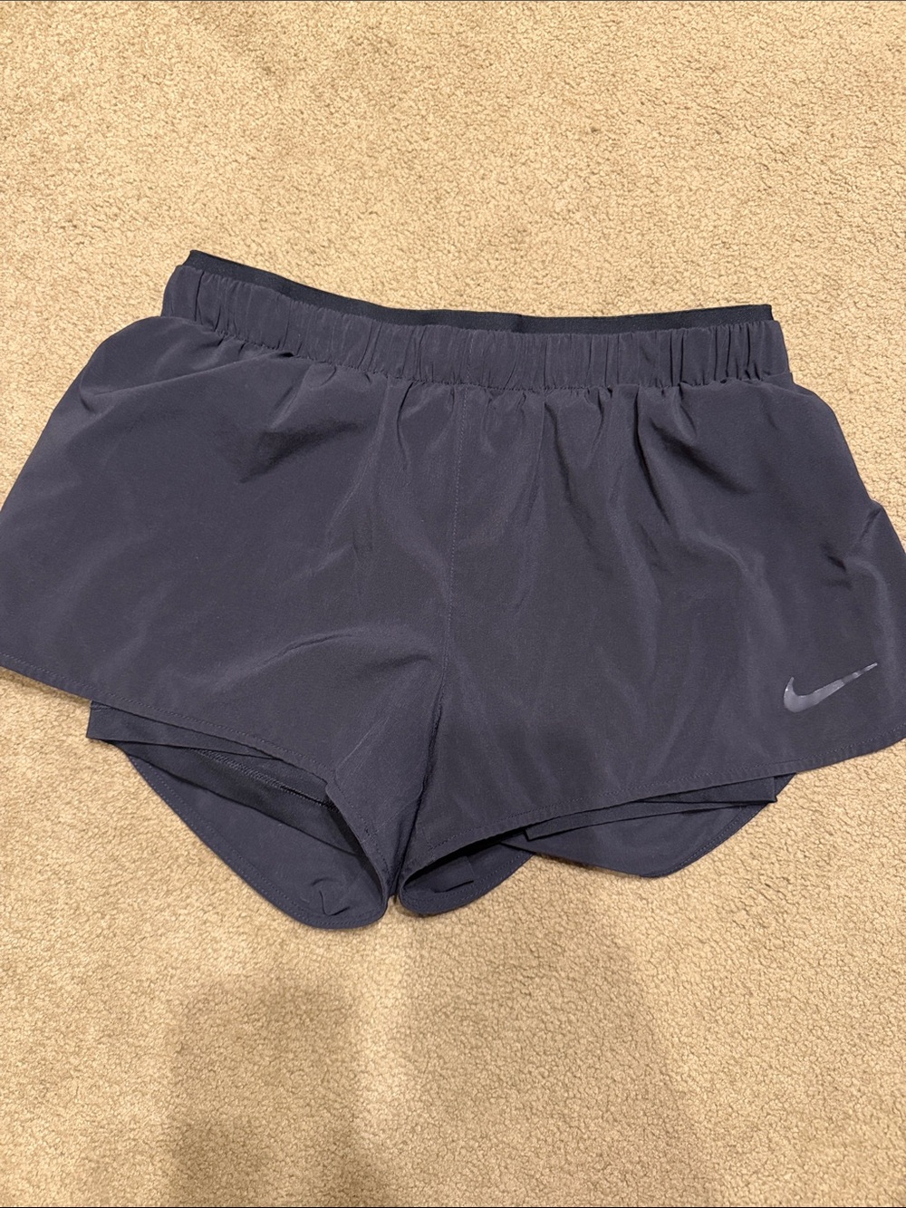 Woman’s black Nike Dri-FIT running shorts